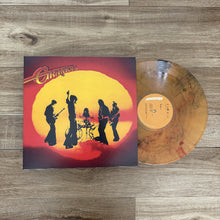 Charger l'image dans la galerie, Vinyl record with cover featuring silhouettes of musicians against a sunset background on a wooden surface.