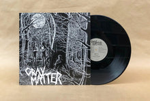 Charger l'image dans la galerie, Vinyl record with cover featuring a black and white illustration of people in a forest, on a beige background.