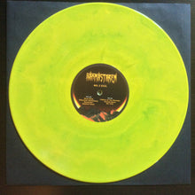 Cargar imagen en el visor de la galería, Vinyl record with a neon green disc and black label on a dark background