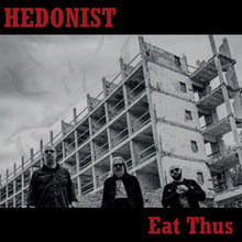 Charger l'image dans la galerie, Black and white album cover featuring three individuals in front of an unfinished building with the band name 'HEDONIST' and album title 'Eat Thus' in bold letters.