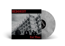 Charger l'image dans la galerie, Black and white album cover featuring three individuals in front of an unfinished building with the band name 'HEDONIST' and album title 'Eat Thus' in bold letters.