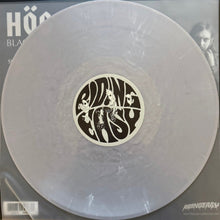 Load image into Gallery viewer, Silver vinyl record with a black and white label featuring artistic design, on a gray background.