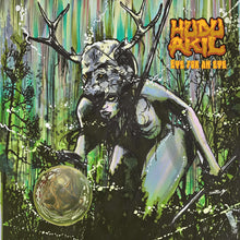 Load image into Gallery viewer, Album cover with a stylized figure holding a coin in a forest setting, featuring the band 'Huda Artie'.
