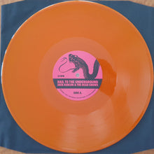 Charger l'image dans la galerie, Orange vinyl record with a pink label featuring text and graphics on a blue background