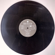 Cargar imagen en el visor de la galería, Vinyl record with a label on a white background