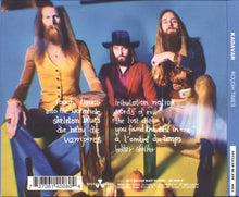 Load image into Gallery viewer, Album cover with three band members and text on a blue background