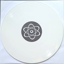 Cargar imagen en el visor de la galería, Round white object with a central black circle featuring an atom symbol on a white background