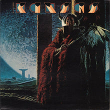 Load image into Gallery viewer, The cover of the 'Kansas - Monolith' CD showing a figure in a red robe against a dark, eerie backdrop with a monolithic structure in the distance.