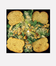 Cargar imagen en el visor de la galería, Caesar salad with croutons and dressing on a black background