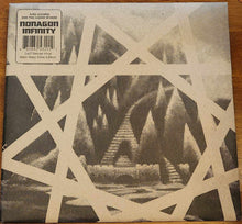 Cargar imagen en el visor de la galería, Album cover with geometric design and text on a wooden surface