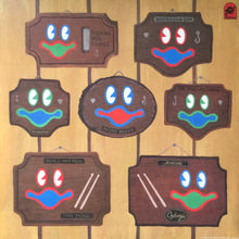 Load image into Gallery viewer, Set of cartoonish face signs with colorful expressions on a wooden background