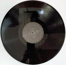 Charger l'image dans la galerie, Black vinyl record with a geometric label on a white background