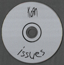 Cargar imagen en el visor de la galería, CD with 'Korn Issues' text on a gray background