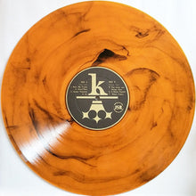 Cargar imagen en el visor de la galería, Vinyl record with a marbled orange design and a label in the center on a white background