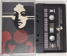 Cargar imagen en el visor de la galería, Cassette tape with cover featuring a stylized face design and text.