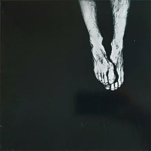 Cargar imagen en el visor de la galería, Black and white image of a person's feet on a dark background