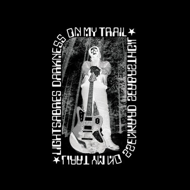 Person holding a guitar with text 'On My Trail' and 'Lightsabes Darkness' on a black background