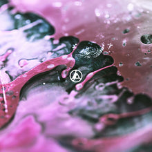 Load image into Gallery viewer, Close-up of a pink and black object with water droplets on a pink background