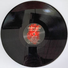 Cargar imagen en el visor de la galería, Vinyl record with a red and black label on a white background