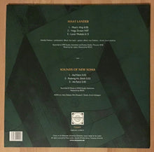 Charger l'image dans la galerie, Vinyl record sleeve with text and a logo on a wooden surface