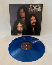 Charger l'image dans la galerie, Blue vinyl record with 'Magick Potion' album cover featuring three faces.