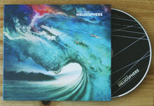Charger l'image dans la galerie, Vinyl record with a colorful cover titled 'Heliosphere' on a wooden surface.