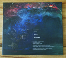 Charger l'image dans la galerie, Album cover with space-themed design and tracklist on a wooden surface