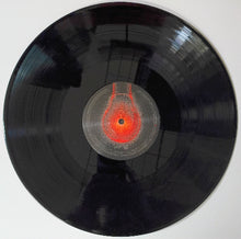 Cargar imagen en el visor de la galería, Black vinyl record with a red light bulb design on a white background