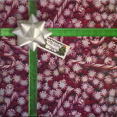 Gift with candy-themed wrapping paper, green ribbon, and silver bow.