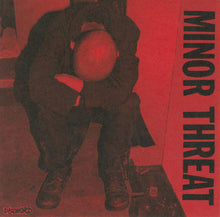 Charger l'image dans la galerie, Album cover with a person sitting on the floor against a red background, featuring the text 'Minor Threat' and 'Dischord'.