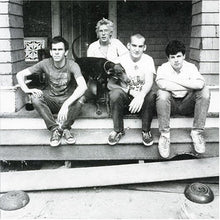 Load image into Gallery viewer, Four young men and a dog sitting on a porch with a brick building in the background.