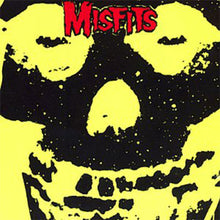 Load image into Gallery viewer, Skull with yellow eyes and black outline, featuring the word 'Misfits' in red at the top.