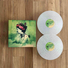 Load image into Gallery viewer, Vinyl records with a cover featuring an artistic illustration on a wooden surface