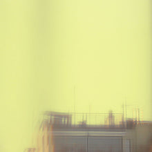 Load image into Gallery viewer, Futuristic cityscape with tall buildings and a yellow-orange sky.