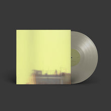 Load image into Gallery viewer, Vinyl record with a yellow cover on a dark background