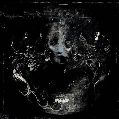 Black and white illustration of a ram's skull with floral elements on a dark background