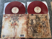 Charger l'image dans la galerie, Red vinyl records with a detailed cover on a textured surface