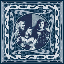Cargar imagen en el visor de la galería, Vinyl record cover for 'Ocean' featuring a group photo of three individuals holding violins and a bass, with a circular blue and white design around them.