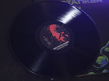 Cargar imagen en el visor de la galería, Vinyl record with a label on a dark surface