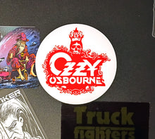 Charger l'image dans la galerie, Ozzy Osbourne logo sticker on a dark surface with other stickers.