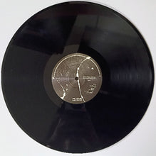 Charger l'image dans la galerie, Vinyl record with a label on a white background
