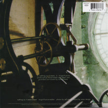 Load image into Gallery viewer, Close-up of mechanical gears with text on a record label
