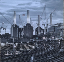 Cargar imagen en el visor de la galería, Industrial scene with cranes and buildings under a cloudy sky