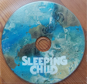 Sleeping Child - Supernovian Remnant CD on a wooden surface