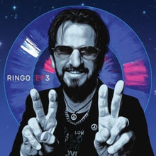 Load image into Gallery viewer, Cover art for Ringo EP3 cassette featuring Ringo Starr in monochrome with peace signs, against a cosmic space background with pink and blue elements.