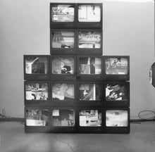 Load image into Gallery viewer, Stack of small TVs displaying various images on a plain background