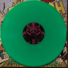 Cargar imagen en el visor de la galería, Green vinyl record with a black label featuring a pink and white design on a colorful comic book background.