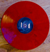 Cargar imagen en el visor de la galería, Red vinyl record with a blue label on a wooden surface