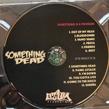 Load image into Gallery viewer, CD with 'Something Dead' album tracklist and branding on a reflective surface