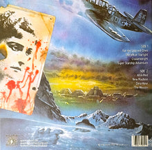 Charger l&#39;image dans la galerie, Album cover with a futuristic landscape, airplane, and face with red markings.